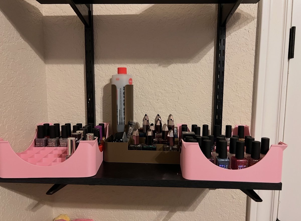 3D printed honeycomb nail polish organizers mounted on a floating shelf